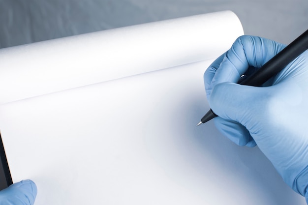 A close-up image of a hand holding a medical document, with a pen pointing towards a highlighted section. The background is blurred, focusing attention on the details of the form.