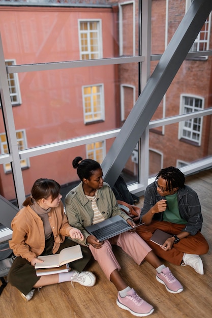 A diverse group of students studying together in a modern library, symbolizing the educational opportunities made possible through diligent saving and investment in a 529 plan.