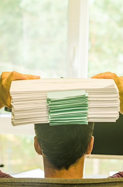 A close-up of various documents such as student loan statements, HSA contribution records, and charitable donation receipts, arranged neatly on a desk to signify potential tax deductions.