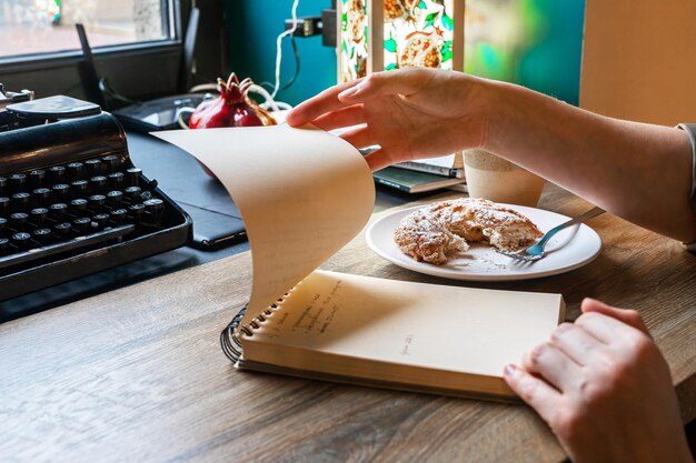 An image showcasing a freelancer working at a coffee shop, surrounded by receipts and invoices, highlighting the various deductible expenses for self-employed individuals.