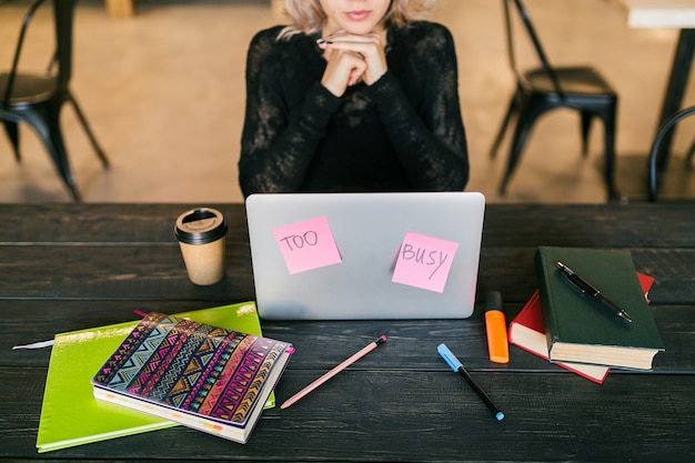 A freelancer working on a laptop, with sticky notes displaying financial goals and reminders. The image conveys proactive financial planning for freelancers.