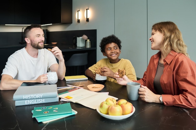A family sitting at a table, looking at a personal financial plan together. They are smiling and engaged, showing collaboration and a shared sense of financial responsibility.