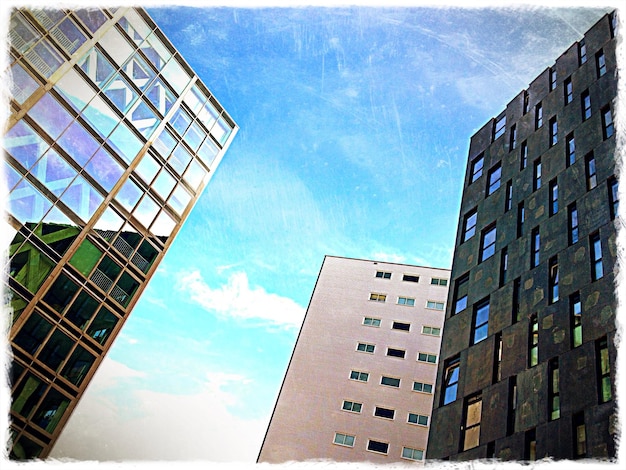 A collage of images depicting various types of real estate investments: a modern apartment building, a commercial office space, a plot of land with potential for development, and a REITs investment dashboard on a laptop screen.