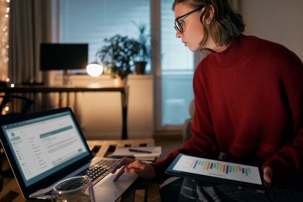 A person reviewing a budget spreadsheet on a laptop with various expense categories highlighted, representing the diligent tracking of business expenses.