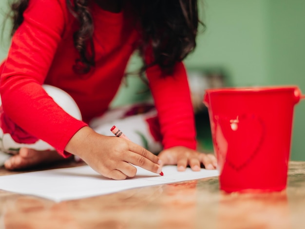 A close-up image of hands filling out a student loan forgiveness application form on a well-organized desk with a laptop and a pen.