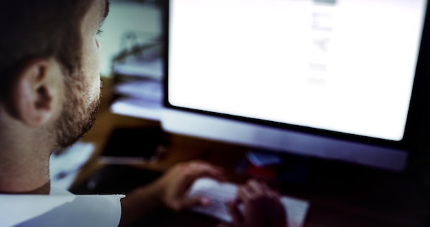 A close-up shot of an intern working on a computer, with code visible on the screen. The intern is focused and determined, showcasing the technical skills being developed during the internship.