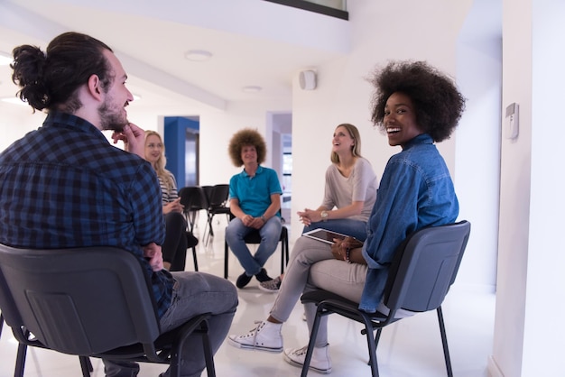 A diverse group of students participating in a career counseling session, discussing their skills, interests, and potential college majors with a career advisor.