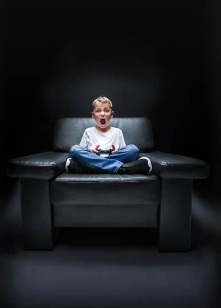 A person sitting on a couch, eyes glued to a large screen displaying a dramatic scene from a TV show. The lighting in the room is dim, emphasizing the intense viewing experience. A bowl of popcorn sits on the coffee table.